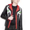 (Front): Photo of a model wearing a black leather jacket. The jacket is a motorcycle cut with a red hood and a red leather lining that is visible inside the cuffs and the folded down collar. There is also a strip of red leather either side of the front zipper. Where breast pockets typically would be on a jacket, there are [handpainted/patched] green eyes surrounded by white details. The collar has metal pop buttons to hold it in place. (Back): Photo of the same black leather jacket with a red hood. The jacket is a motorcycle cut. The inside of the hood has a mesh lining.