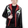 (Front): Photo of a model wearing a black leather jacket. The jacket is a motorcycle cut with a red hood and a red leather lining that is visible inside the cuffs and the folded down collar. There is also a strip of red leather either side of the front zipper. Where breast pockets typically would be on a jacket, there are [handpainted/patched] green eyes surrounded by white details. The collar has metal pop buttons to hold it in place. (Back): Photo of the same black leather jacket with a red hood. The jacket is a motorcycle cut. The inside of the hood has a mesh lining.